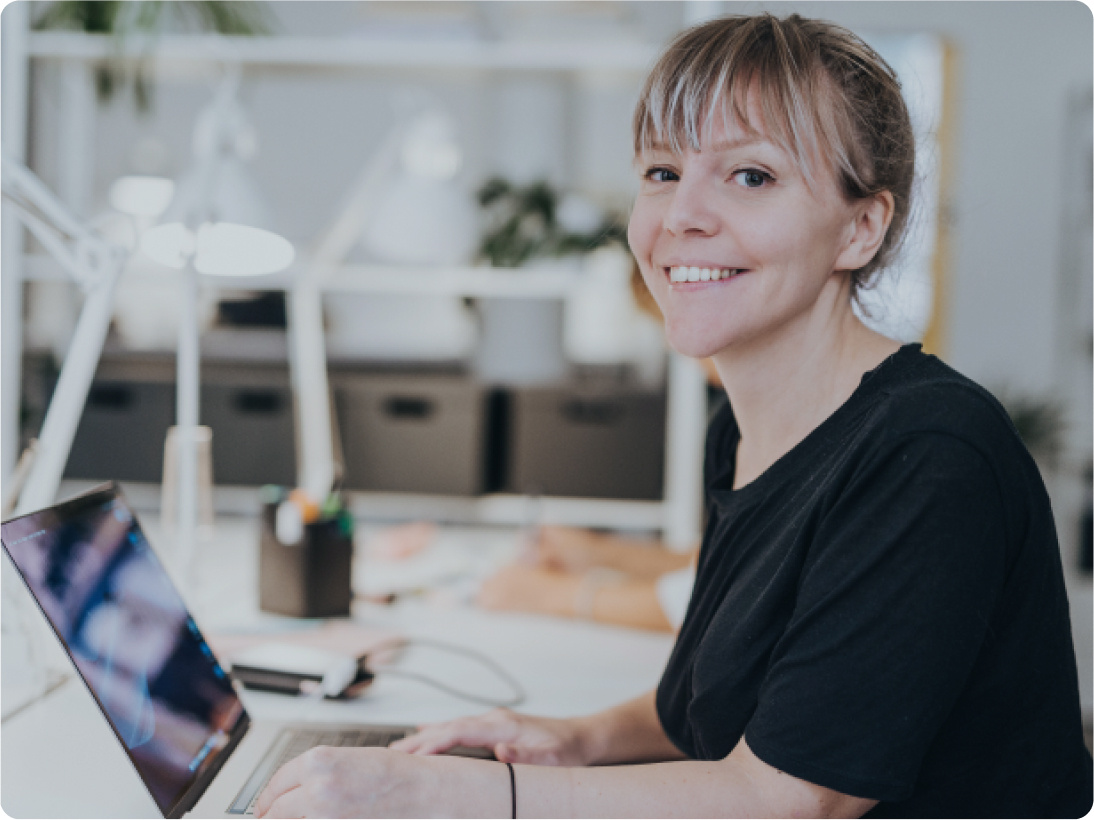 Woman with computer integrating SMS dark